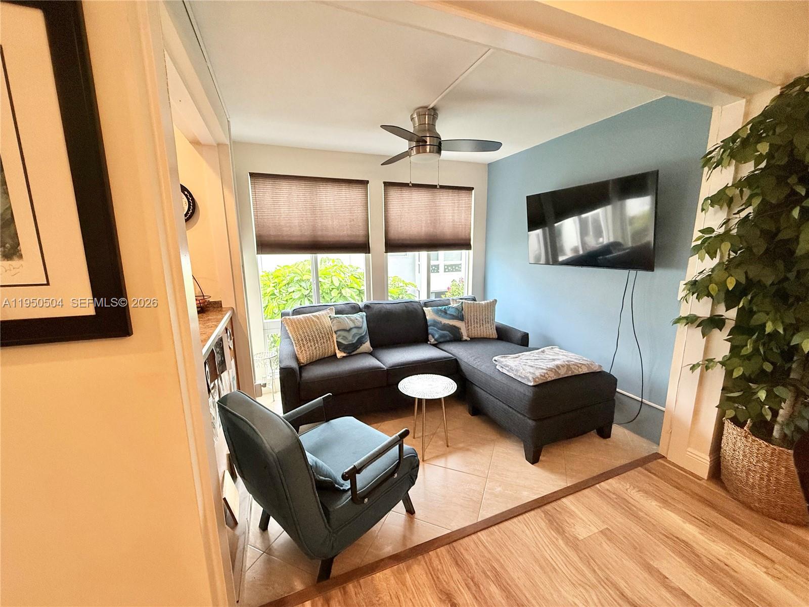 A living room features a blue accent wall, a sectional sofa, and a ceiling fan — 18 Colonial Club Dr # 202, Boynton Beach FL 33435, BOYNTON BEACH, FL