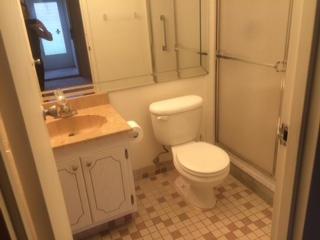A bathroom features a vanity with a sink, a toilet, and a glass-enclosed shower — 482 Monaco K # 482, Delray Beach FL 33446, DELRAY BEACH, FL
