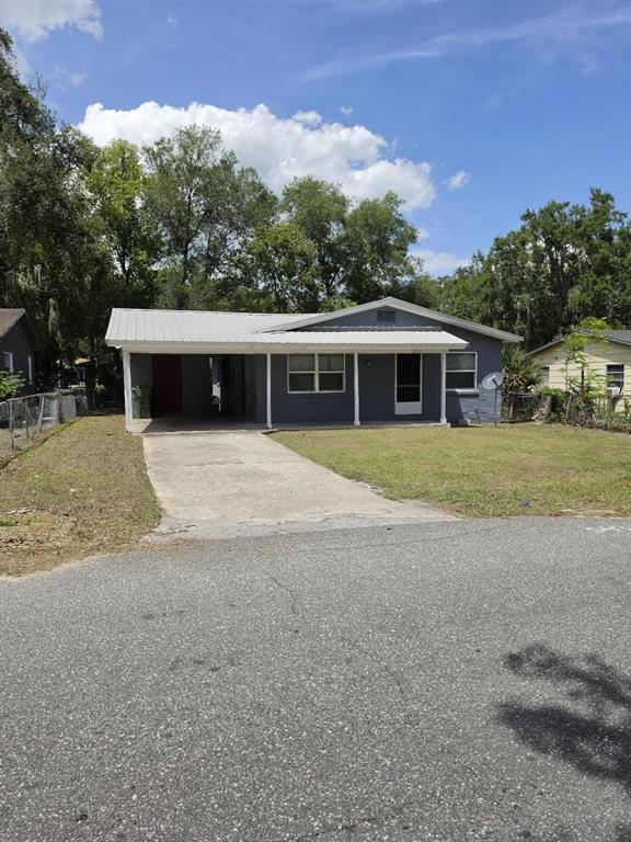 A single-story gray house with a metal roof and an attached carport — 2316 MISPAH AVENUE, LEESBURG, FL