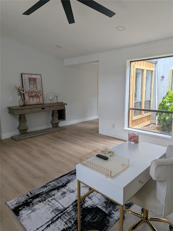 A home office features light wood flooring, a white desk, and a shiplap accent wall — 4212 HOMEWOOD LANE, LAKELAND, FL