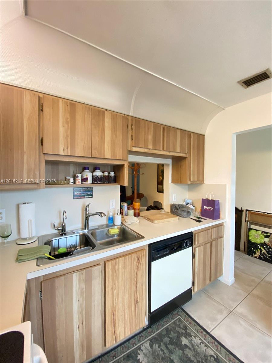 A kitchen features light wood cabinets, a double sink, and a white dishwasher — 432 Bennington Ln # 432, Lake Worth FL 33467, LAKE WORTH, FL
