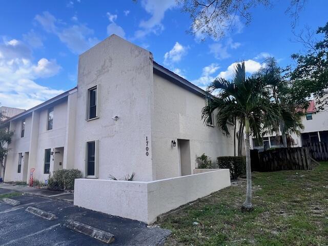 A two-story stucco apartment building with a palm tree and a parking lot — 1679 NW 15th Vista, Boca Raton FL 33432, BOCA RATON, FL