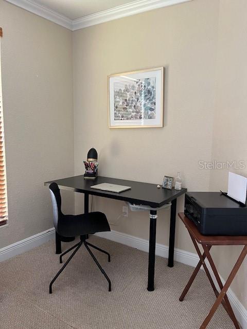 A home office features a black desk, a black chair, and a printer on a stand — 455 ALT 19 S UNIT 65, PALM HARBOR, FL