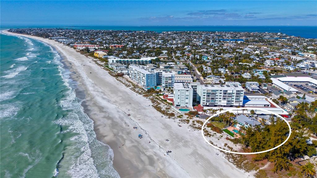 An aerial view of a beachside property with a house circled in white near condos — 95 52ND STREET, HOLMES BEACH, FL