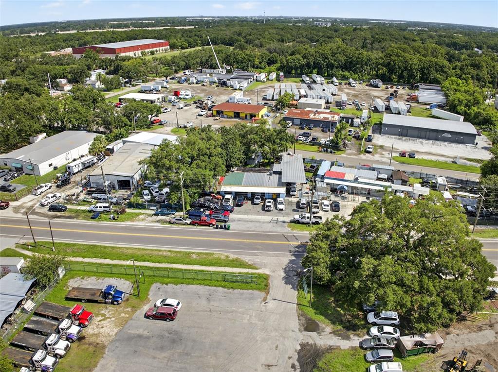 An aerial view shows a commercial property with multiple industrial buildings, parking lots, and vehicles — 6220 E BROADWAY AVENUE, TAMPA, FL