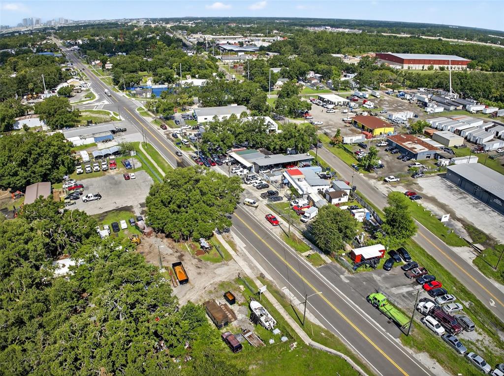 An aerial view shows a commercial property with parking lots and buildings along a road — 6220 E BROADWAY AVENUE, TAMPA, FL