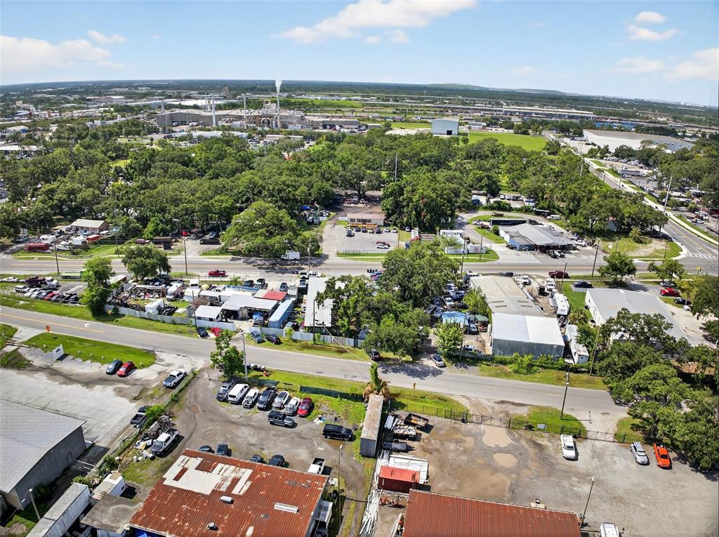 An aerial view shows a commercial property with multiple industrial buildings, parking lots, and trees — 6220 E BROADWAY AVENUE, TAMPA, FL