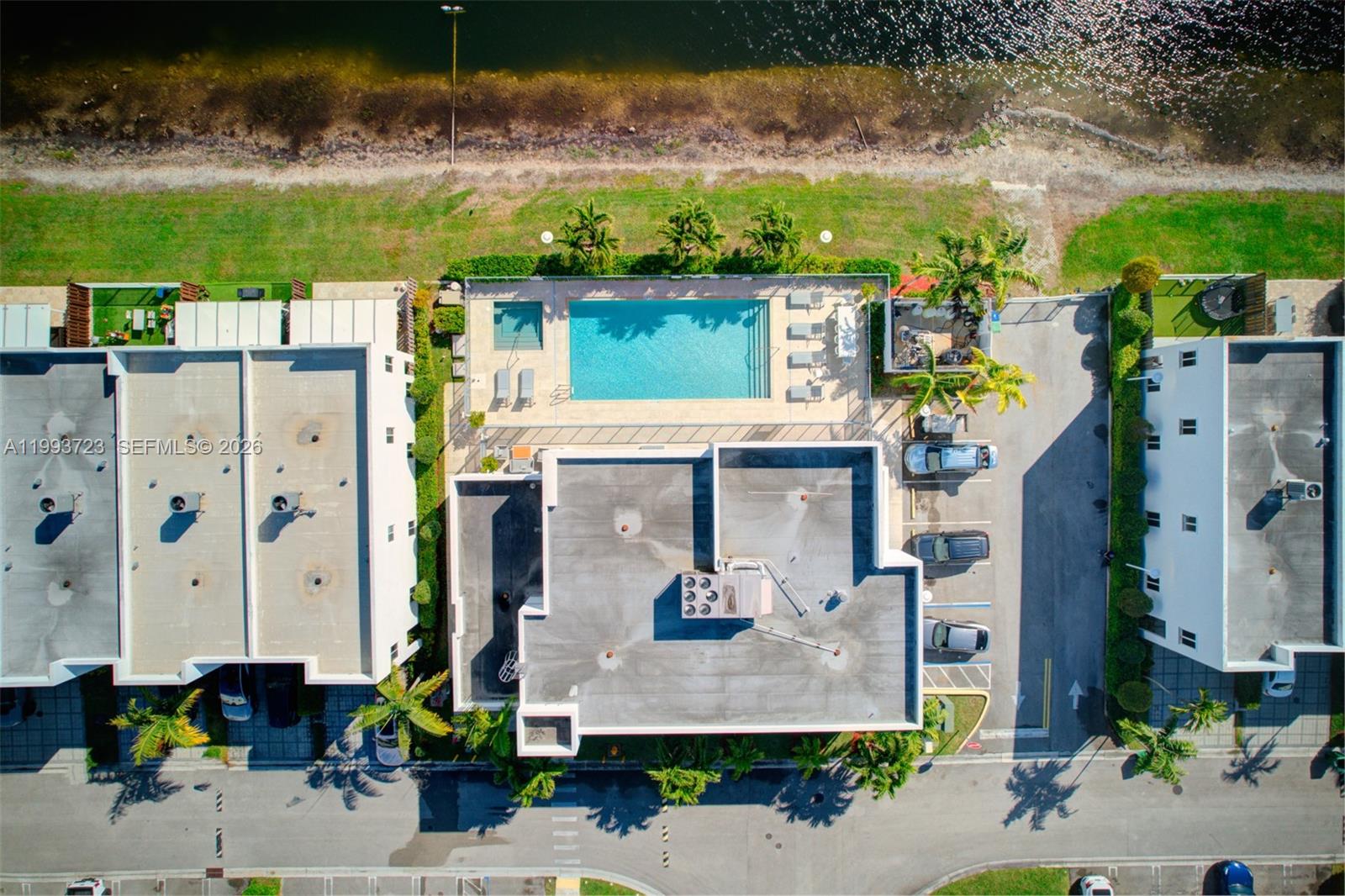 An aerial view shows a residential building complex with a swimming pool and parking area — 7159 NW 102nd Place, Doral FL 33178, DORAL, FL