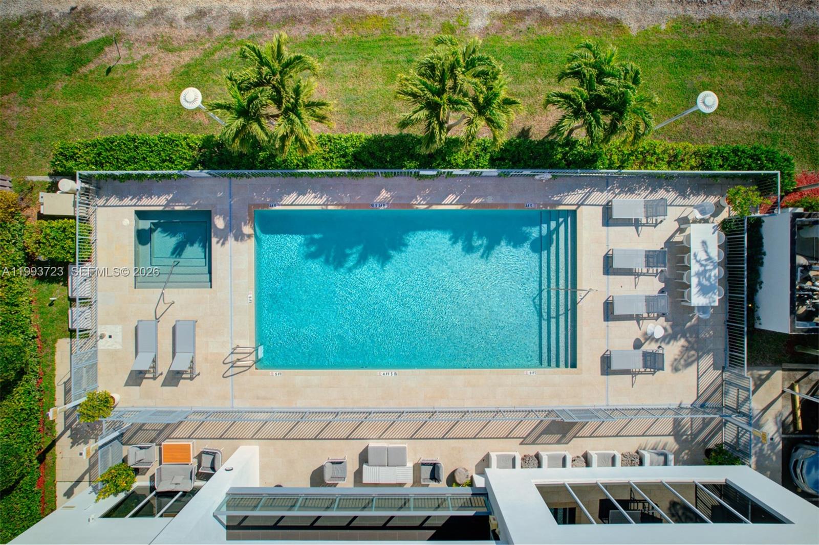 An aerial view shows a rectangular swimming pool with an attached spa and lounge chairs — 7159 NW 102nd Place, Doral FL 33178, DORAL, FL