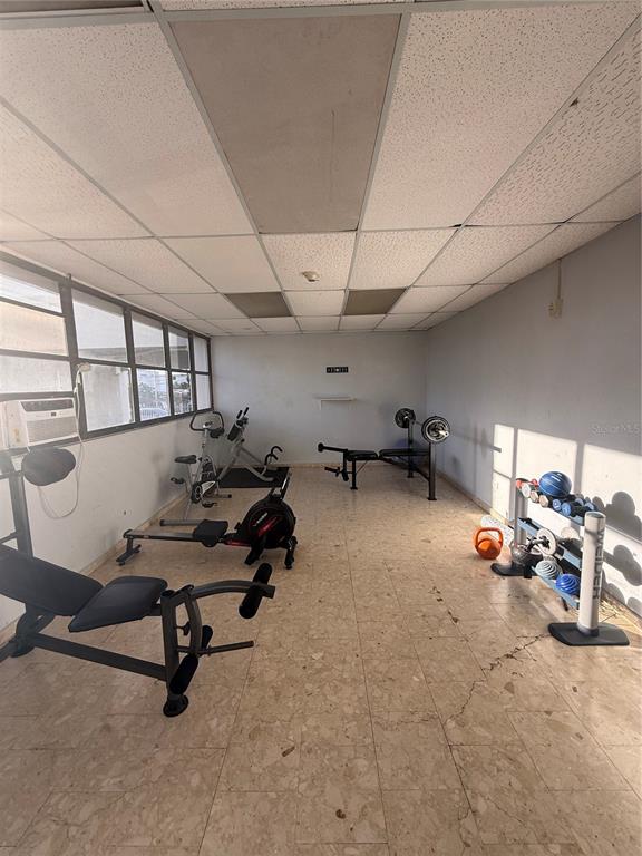 This home gym features a tiled floor, large windows, and various pieces of exercise equipment — . LAUREL UNIT 2306, SAN JUAN, PR