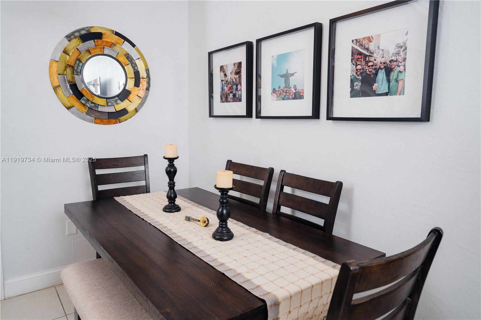 A dining room features a dark wood table, matching chairs, a bench, and wall art — 7901 SW 64th Ave # 6, South Miami FL 33143, SOUTH MIAMI, FL