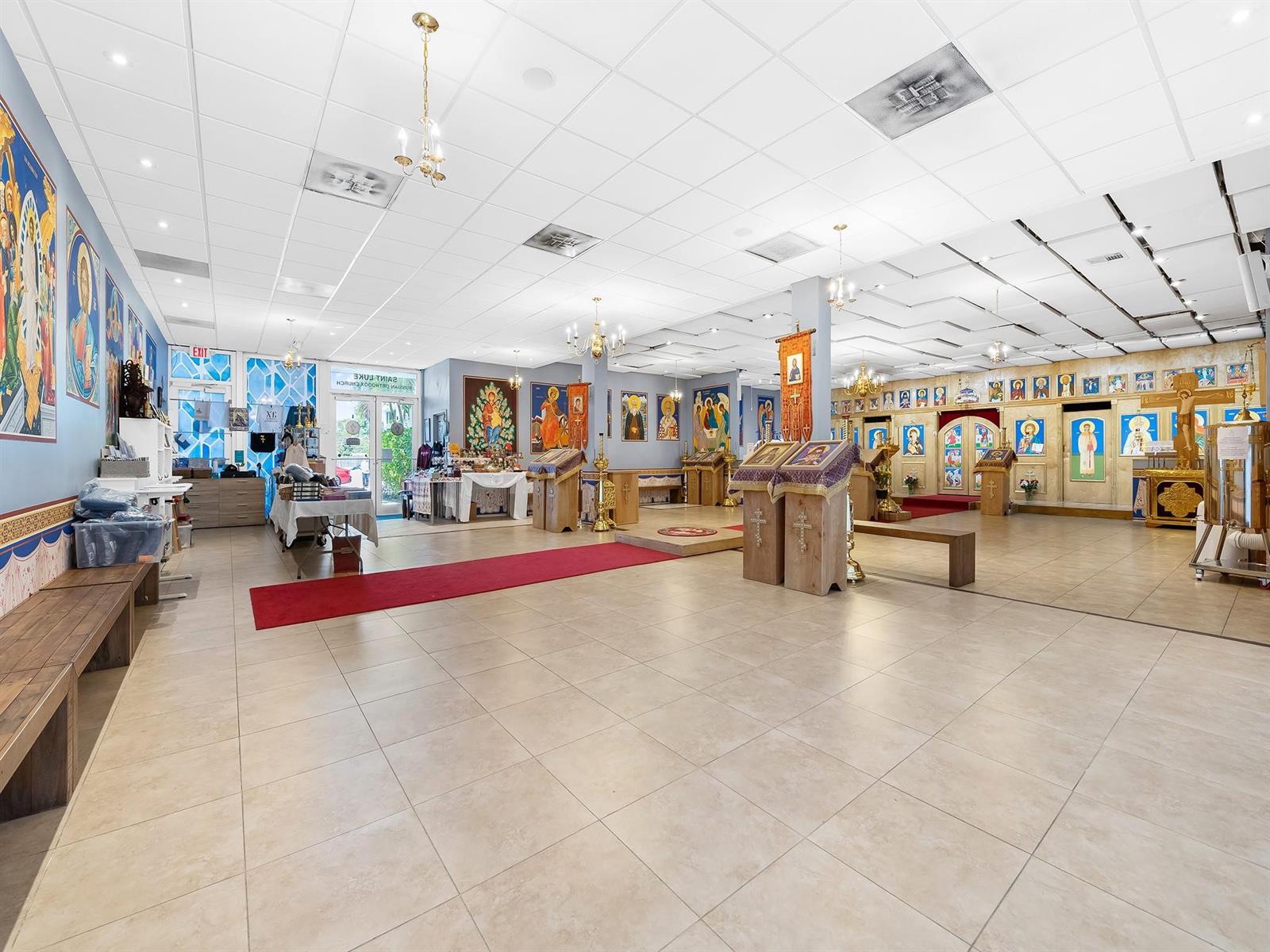 A spacious room with tile flooring, a drop ceiling, and numerous religious icons on walls — 1301 E Atlantic Boulevard Suite 5, Pompano Beach FL 33060, POMPANO BEACH, FL