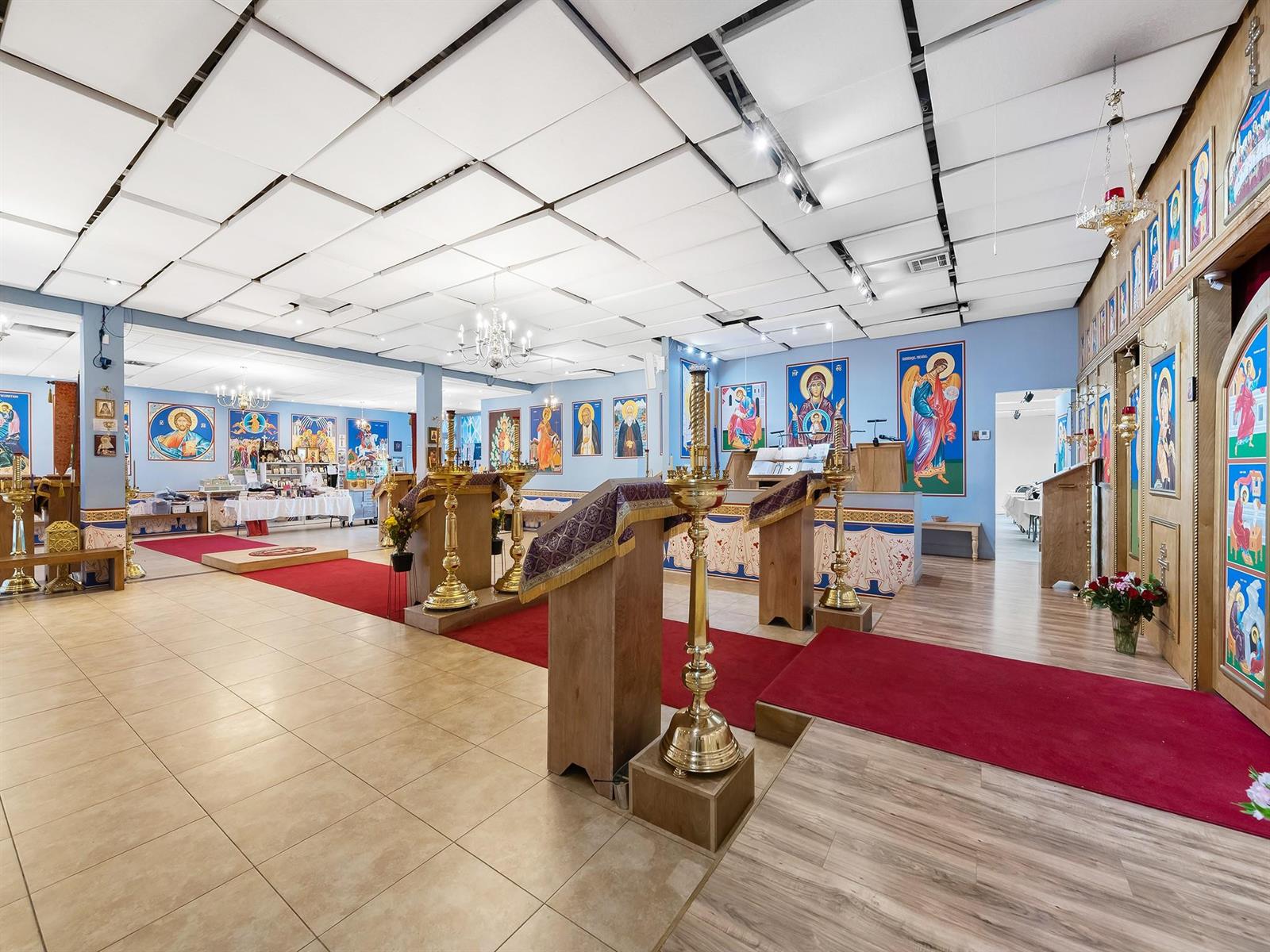 A church interior features tiled floors, red carpets, wooden lecterns, and walls adorned with religious icons — 1301 E Atlantic Boulevard Suite 5, Pompano Beach FL 33060, POMPANO BEACH, FL