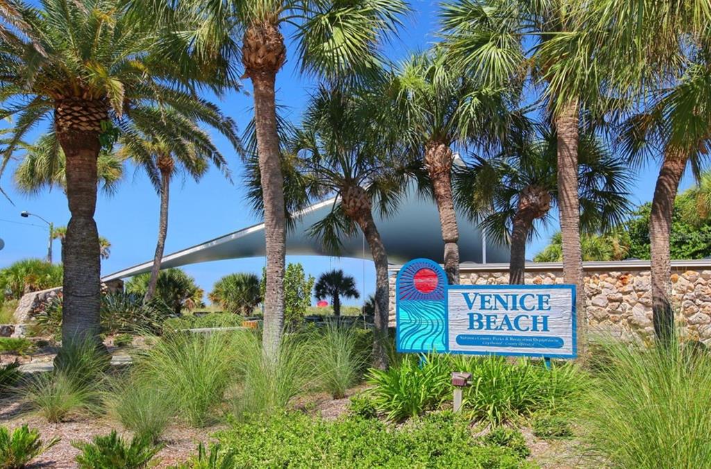 A sign for Venice Beach stands in a landscaped area with palm trees and a pavilion — 425 CERROMAR TERRACE UNIT 359, VENICE, FL