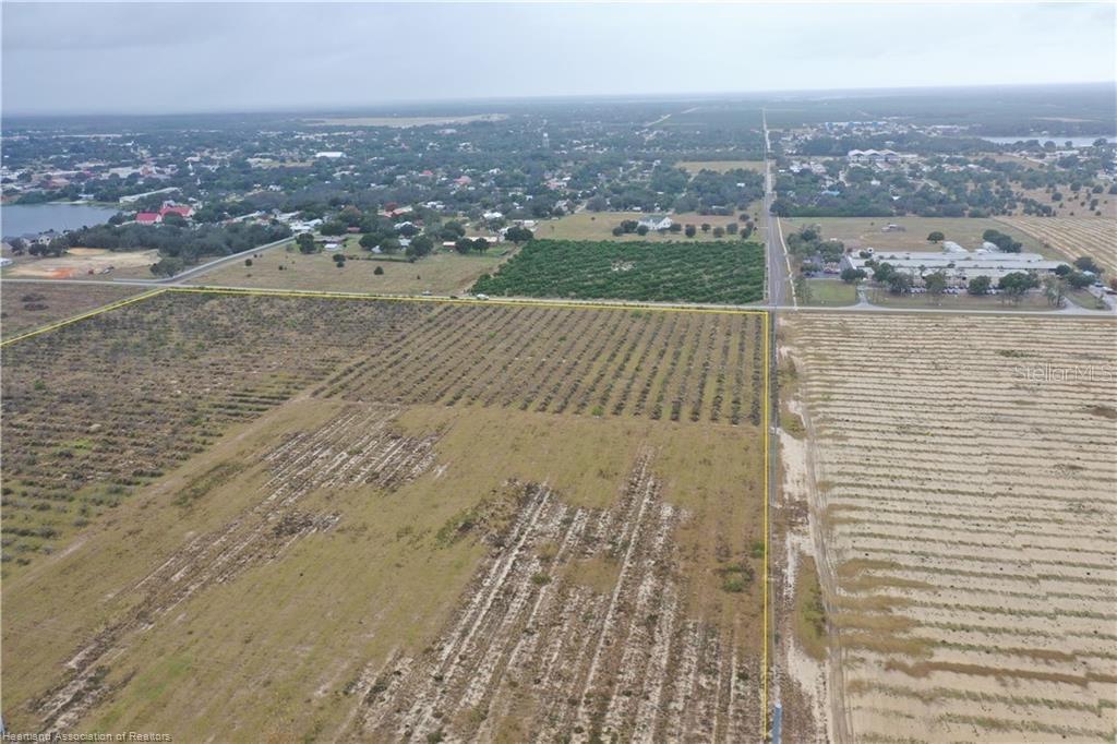 An aerial view shows a large, rectangular plot of land outlined in yellow — 525 E WINTHROP STREET, AVON PARK, FL