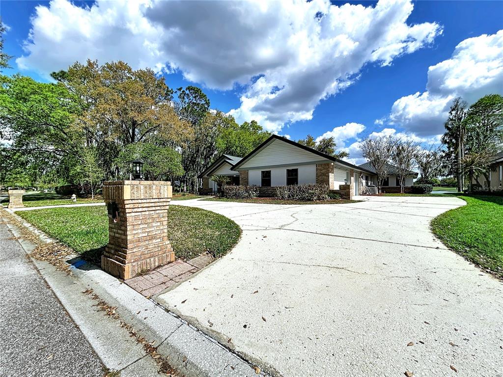A single-story house with a large concrete driveway and a brick mailbox in the foreground — 2881 HAMMOCK DRIVE, PLANT CITY, FL