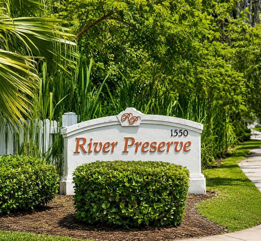 A white stone monument sign for River Preserve sits in front of lush green landscaping — 2607 RIVER PRESERVE COURT UNIT 2607, BRADENTON, FL