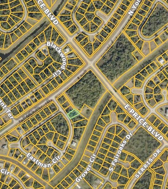 This is a satellite map view showing a vacant residential lot highlighted in green — LOT: 4 EASTMAN CIRCLE, NORTH PORT, FL