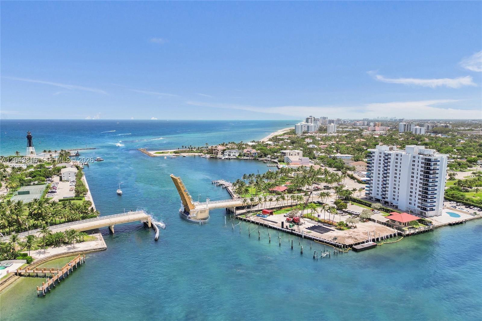 An aerial view shows a drawbridge open over a waterway near a coastal residential area — 2639 N Riverside Dr # 206, Pompano Beach FL 33062, POMPANO BEACH, FL