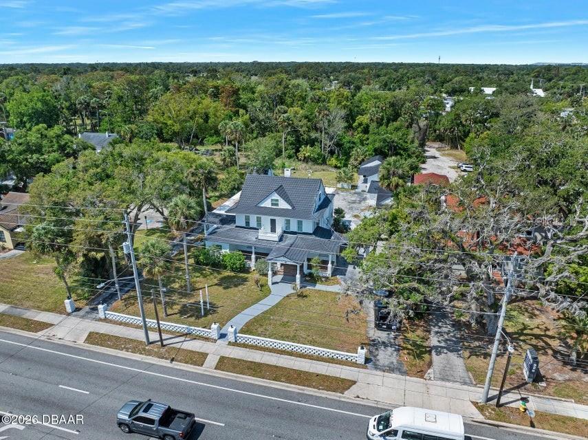 An aerial view shows a two-story house with a dark roof and a front porch — 934 S RIDGEWOOD AVENUE, DAYTONA BEACH, FL