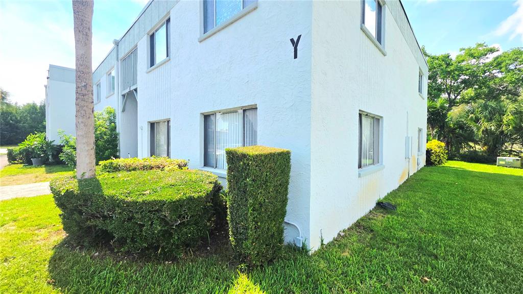 A two-story white apartment building with a letter Y on the exterior wall — 851 N KEENE ROAD UNIT Y7, CLEARWATER, FL