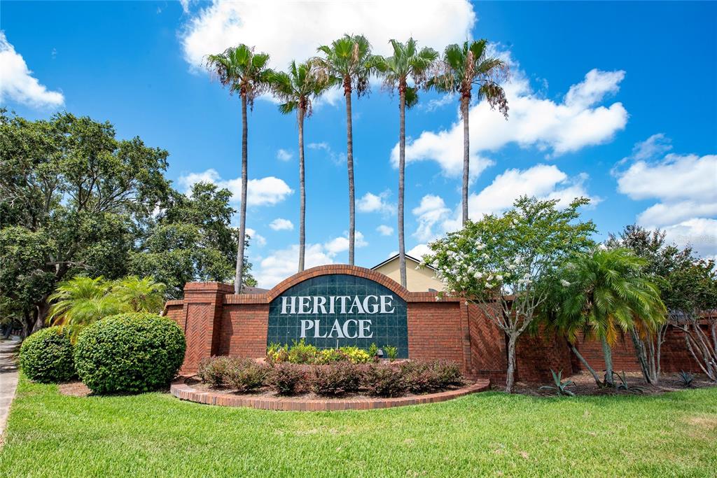 A brick monument sign for Heritage Place stands in front of tall palm trees — 12868 GETTYSBURG CIRCLE, ORLANDO, FL