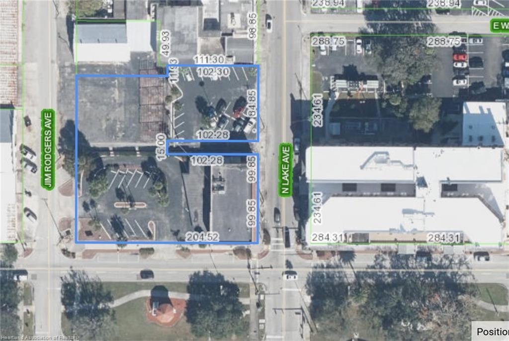 This is an aerial map showing property boundaries outlined in blue over a city street — 2 W Main Street, FL 33825, FL
