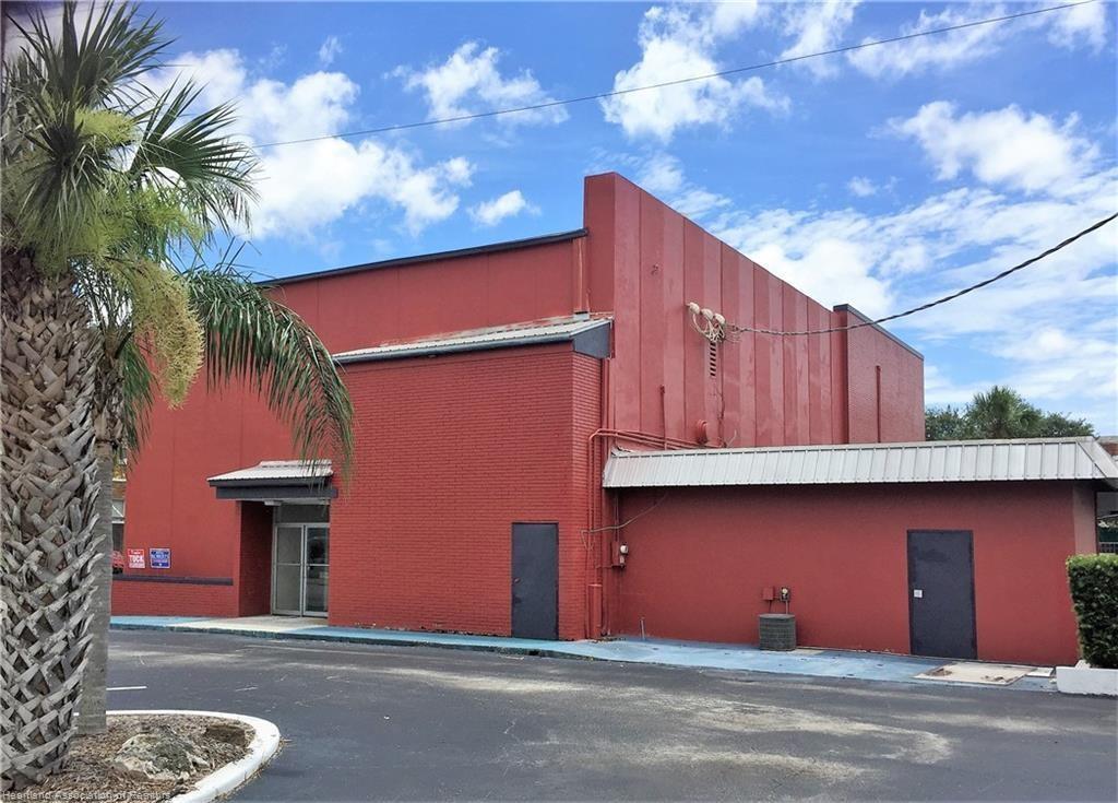 A red commercial building with a metal roof and a palm tree in the foreground — 2 W Main Street, FL 33825, FL