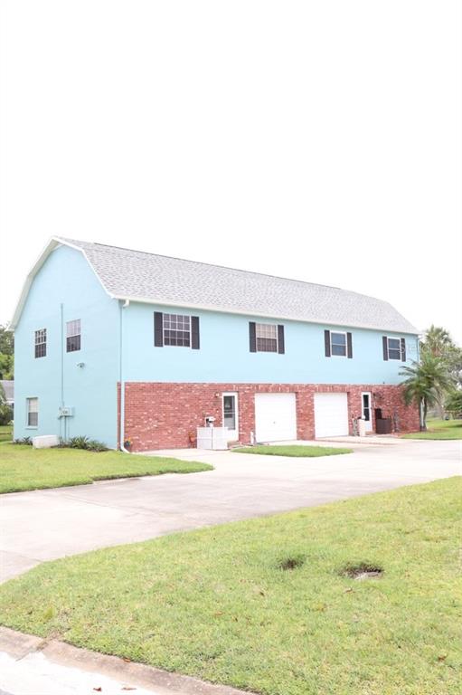 A two-story building with a light blue upper level and a red brick lower level — 6648 TIMBERCOVE LANE UNIT 6648, NEW PORT RICHEY, FL