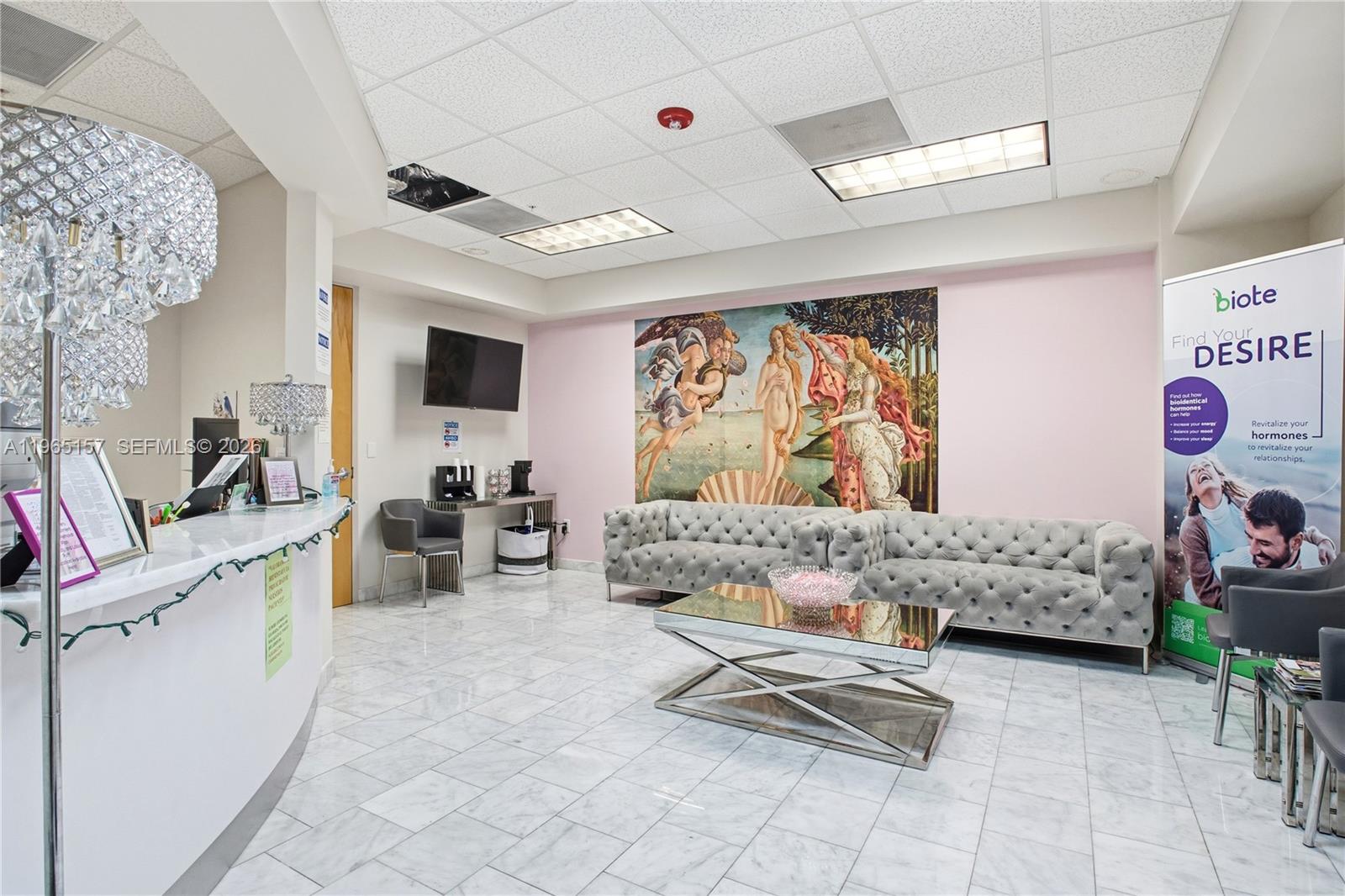 A waiting room features a marble floor, tufted gray sofas, and a large wall mural — 3650 NW 82nd Ave, Doral FL 33166, DORAL, FL