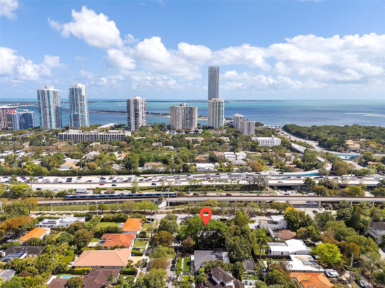 An aerial view shows a residential neighborhood with a red location pin near a highway — 120 SW 24th Rd, Miami FL 33129, MIAMI, FL