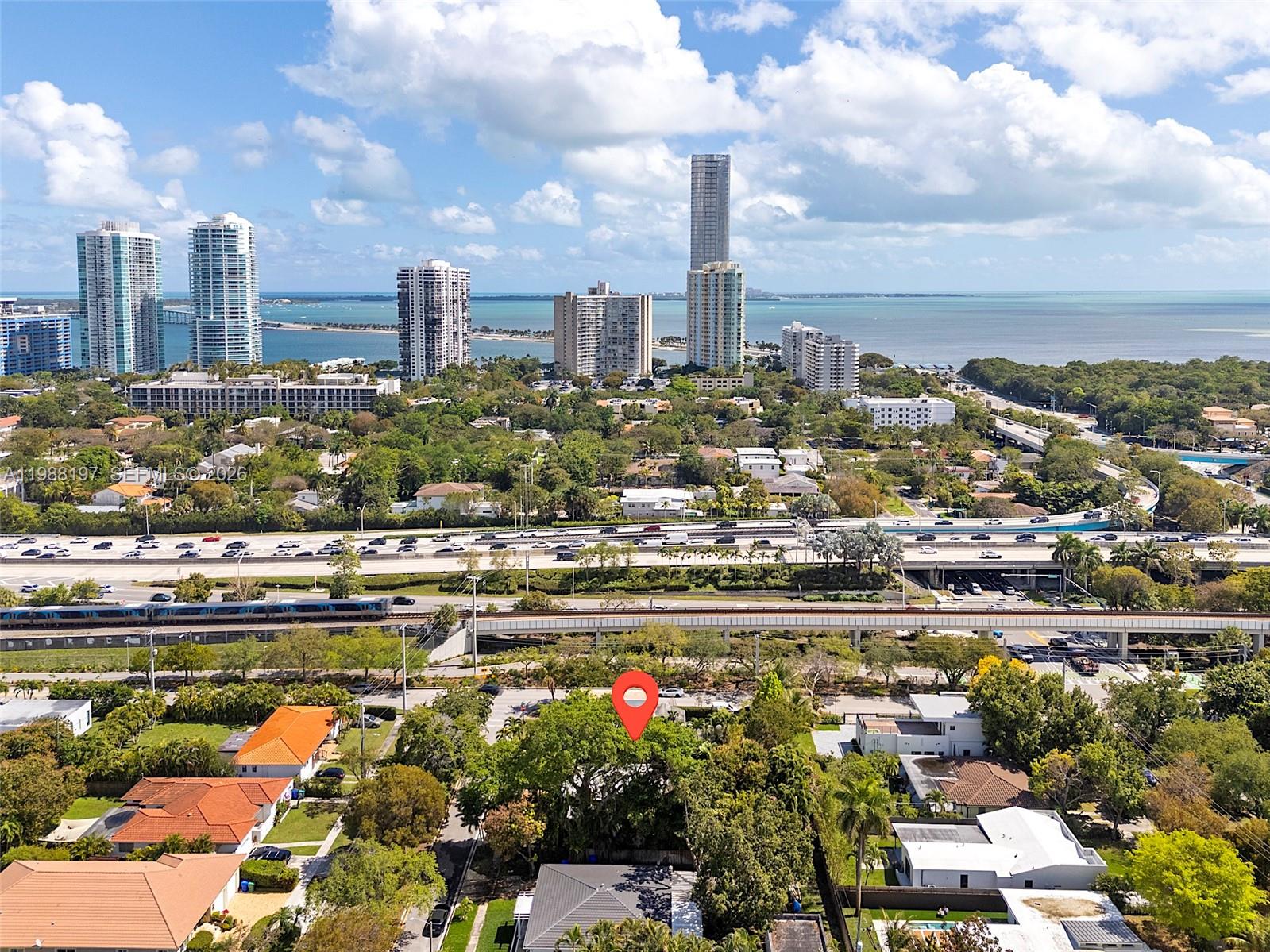 An aerial view shows a residential neighborhood with a red location pin and city skyline — 120 SW 24th Rd, Miami FL 33129, MIAMI, FL
