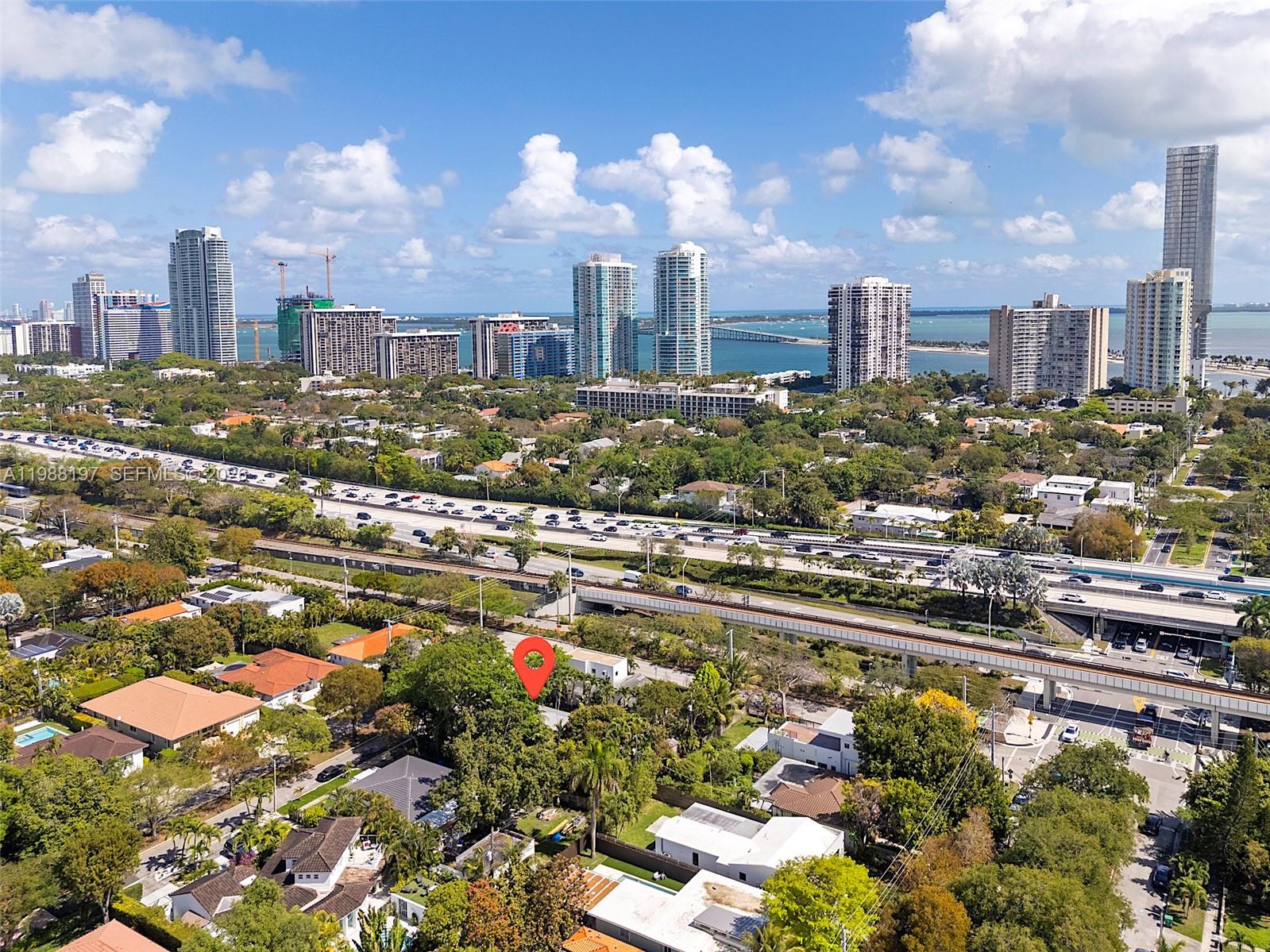 An aerial view shows a residential neighborhood with a red location pin near a highway — 120 SW 24th Rd, Miami FL 33129, MIAMI, FL