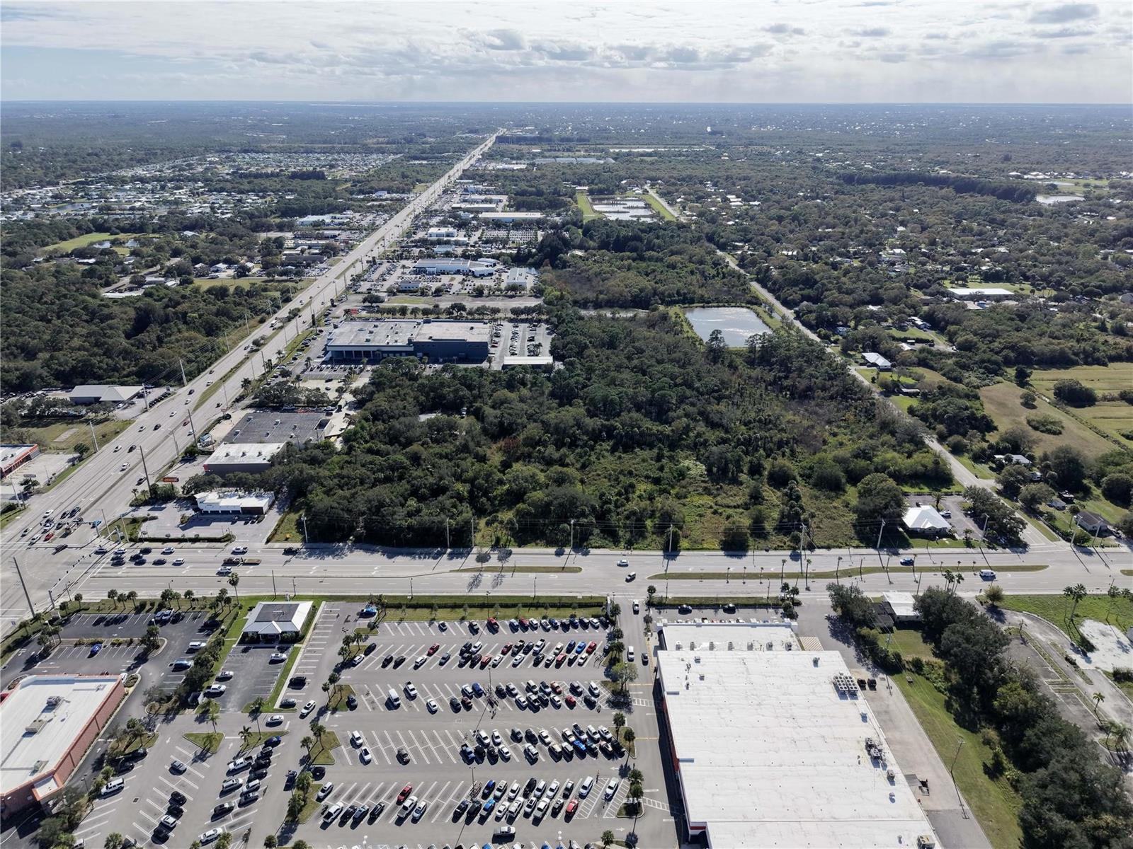 Aerial view of a commercial area with parking lots, buildings, and a highway — 511 W Midway Road, Fort Pierce FL 34982, FORT PIERCE, FL