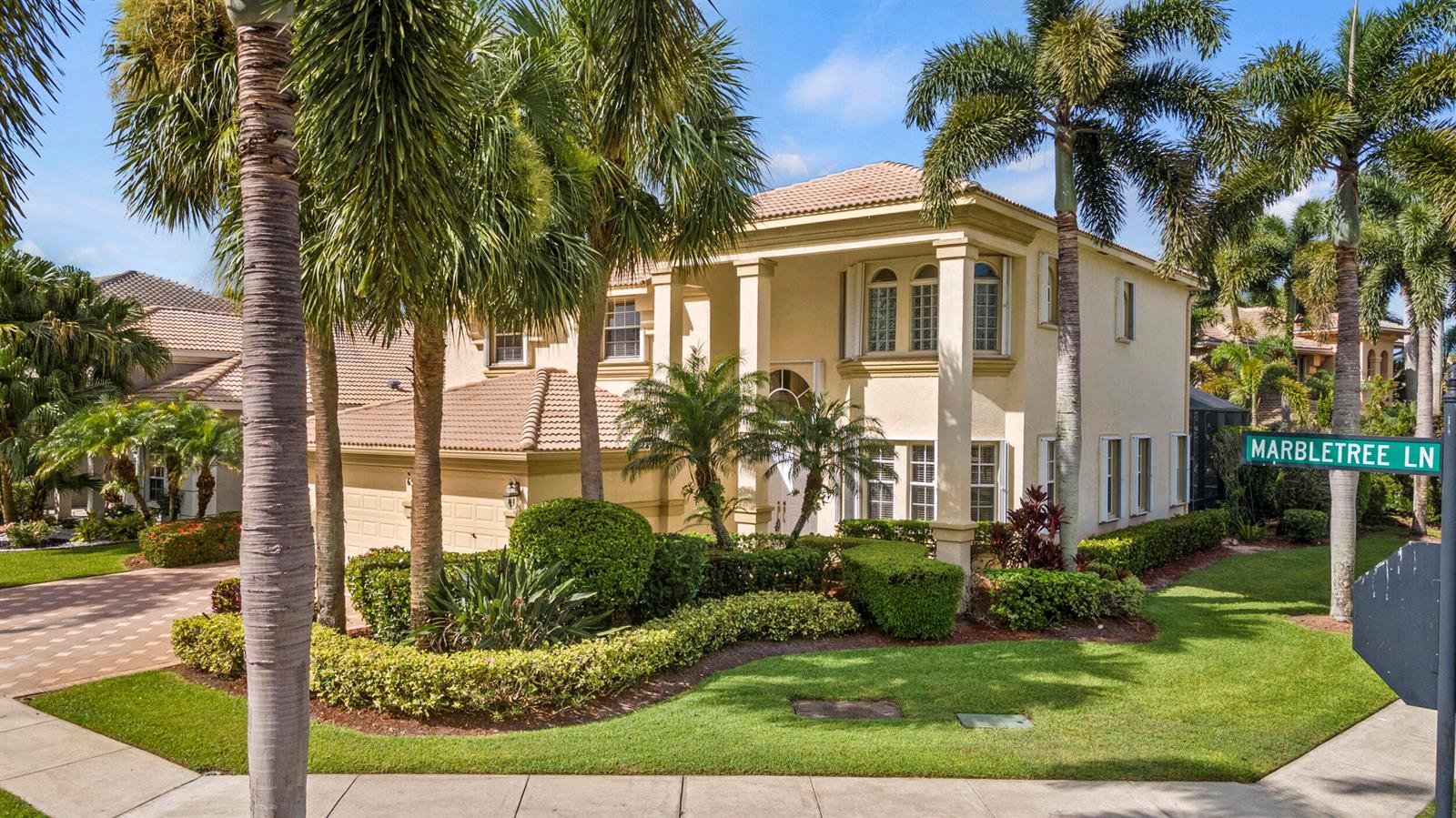 A two-story stucco house with a tiled roof, palm trees, and a landscaped front yard — 6597 Marbletree Lane, Lake Worth FL 33467, LAKE WORTH, FL