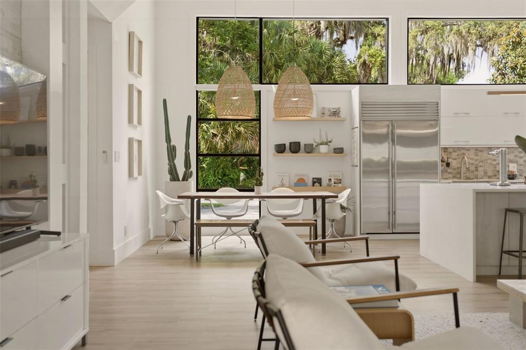 A modern open-concept kitchen and dining area with light wood floors and large windows — 446 MELROSE AVENUE, WINTER PARK, FL
