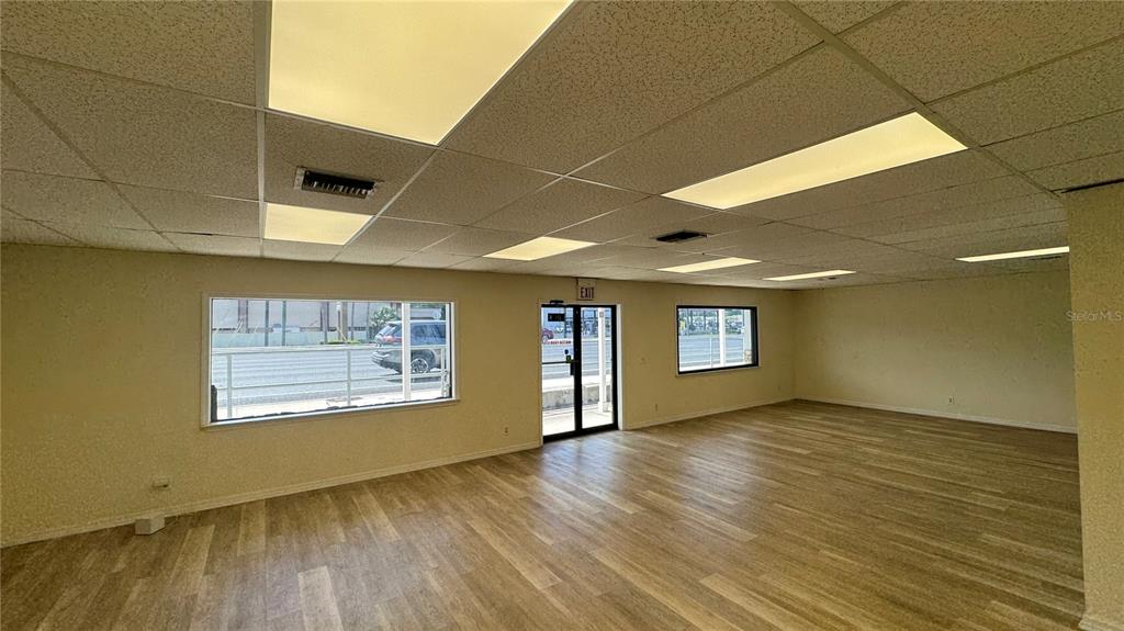 An empty commercial space features light wood-look flooring, beige walls, and a drop ceiling — 4065 S SUNCOAST BOULEVARD, HOMOSASSA, FL