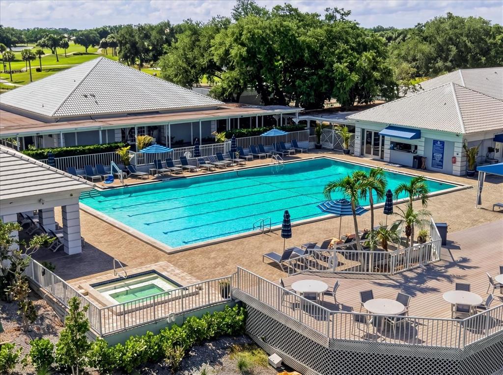 An outdoor swimming pool and hot tub are surrounded by a patio and lounge chairs — 835 WEXFORD BOULEVARD UNIT 301, VENICE, FL