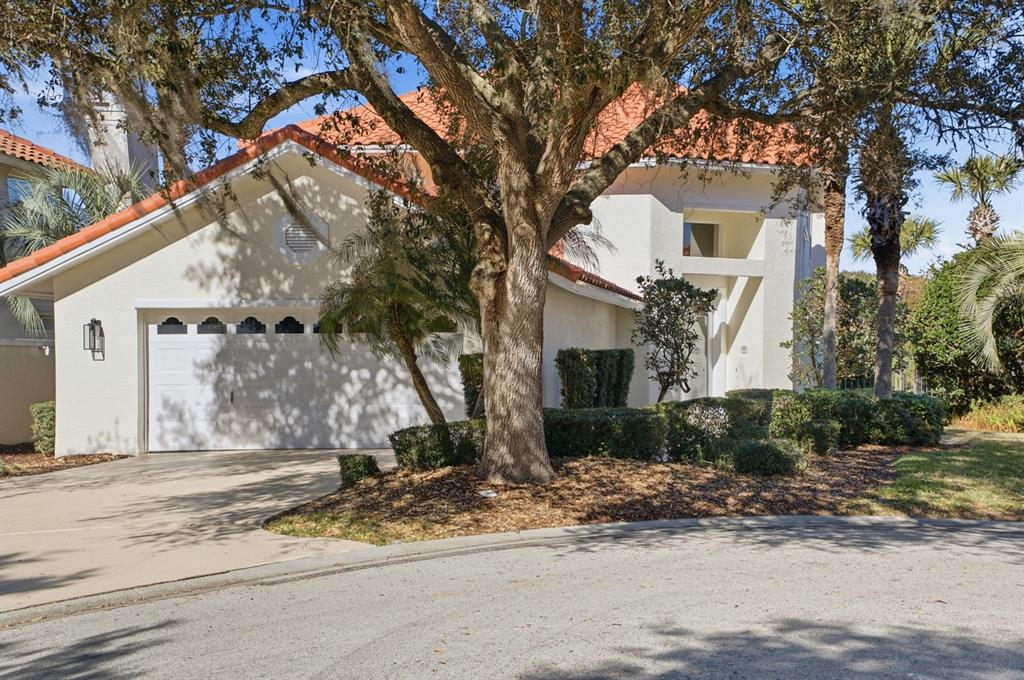 A white house with a red tile roof and a two-car garage — 13 MADEIRA COURT, PALM COAST, FL
