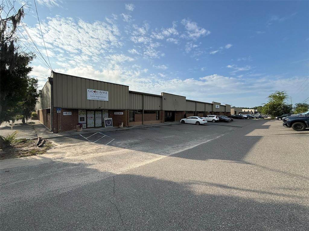 An exterior view of a commercial warehouse building with a parking lot in front — 5950 SW 1ST LANE, OCALA, FL
