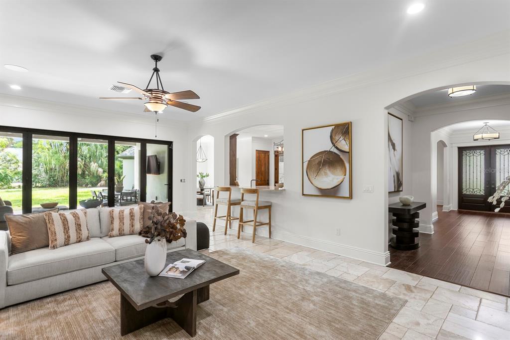 A living room with tile floors, a ceiling fan, and a view of the backyard — 3006 S EMERSON STREET, TAMPA, FL