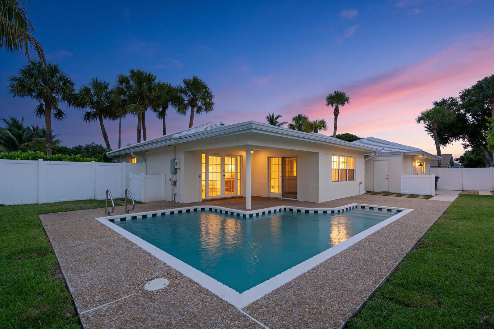A single-story house with a corner swimming pool and palm trees at sunset — 1375 SW 14th Avenue, Boca Raton FL 33486, BOCA RATON, FL