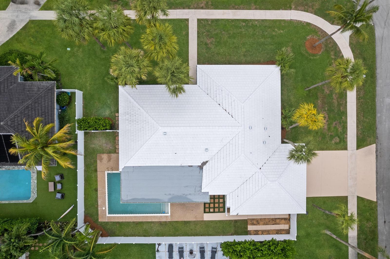 An aerial view shows a house with a white roof, a pool, and surrounding landscaping — 1375 SW 14th Avenue, Boca Raton FL 33486, BOCA RATON, FL