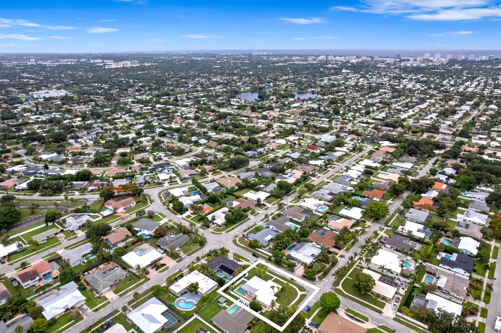 An aerial view shows a single-story house with a pool in a suburban neighborhood — 1375 SW 14th Avenue, Boca Raton FL 33486, BOCA RATON, FL