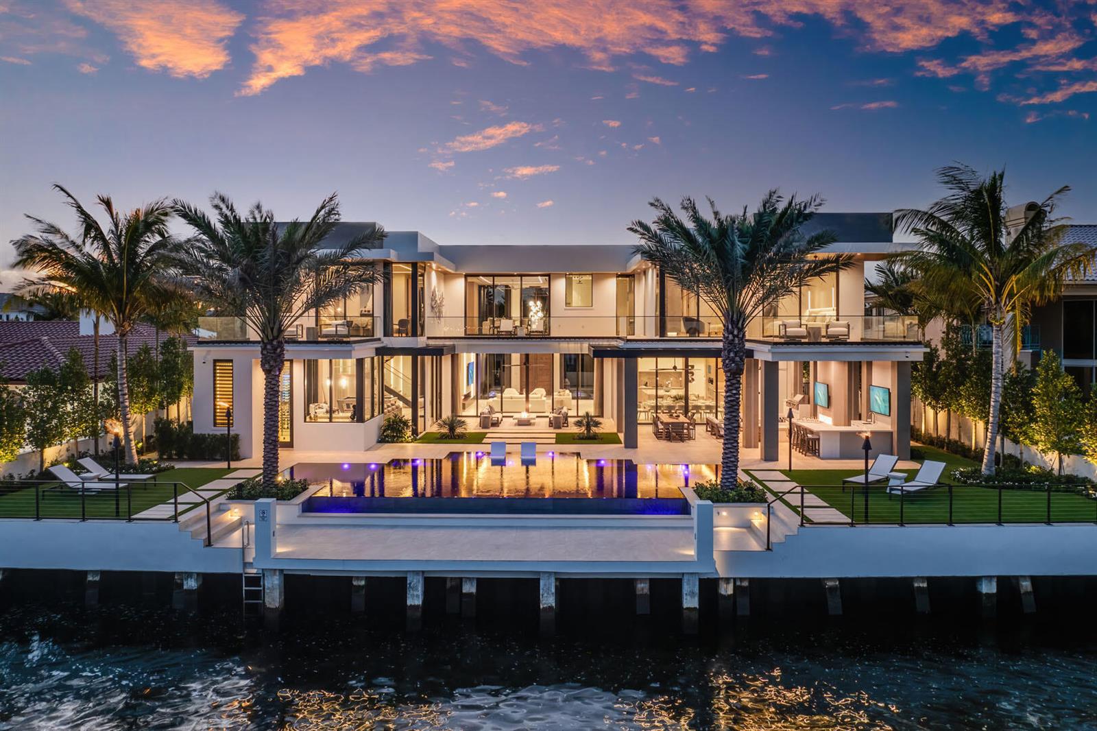 A modern two-story waterfront mansion features a swimming pool, palm trees, and a private dock — 1520 Royal Palm Way, Boca Raton FL 33432, BOCA RATON, FL