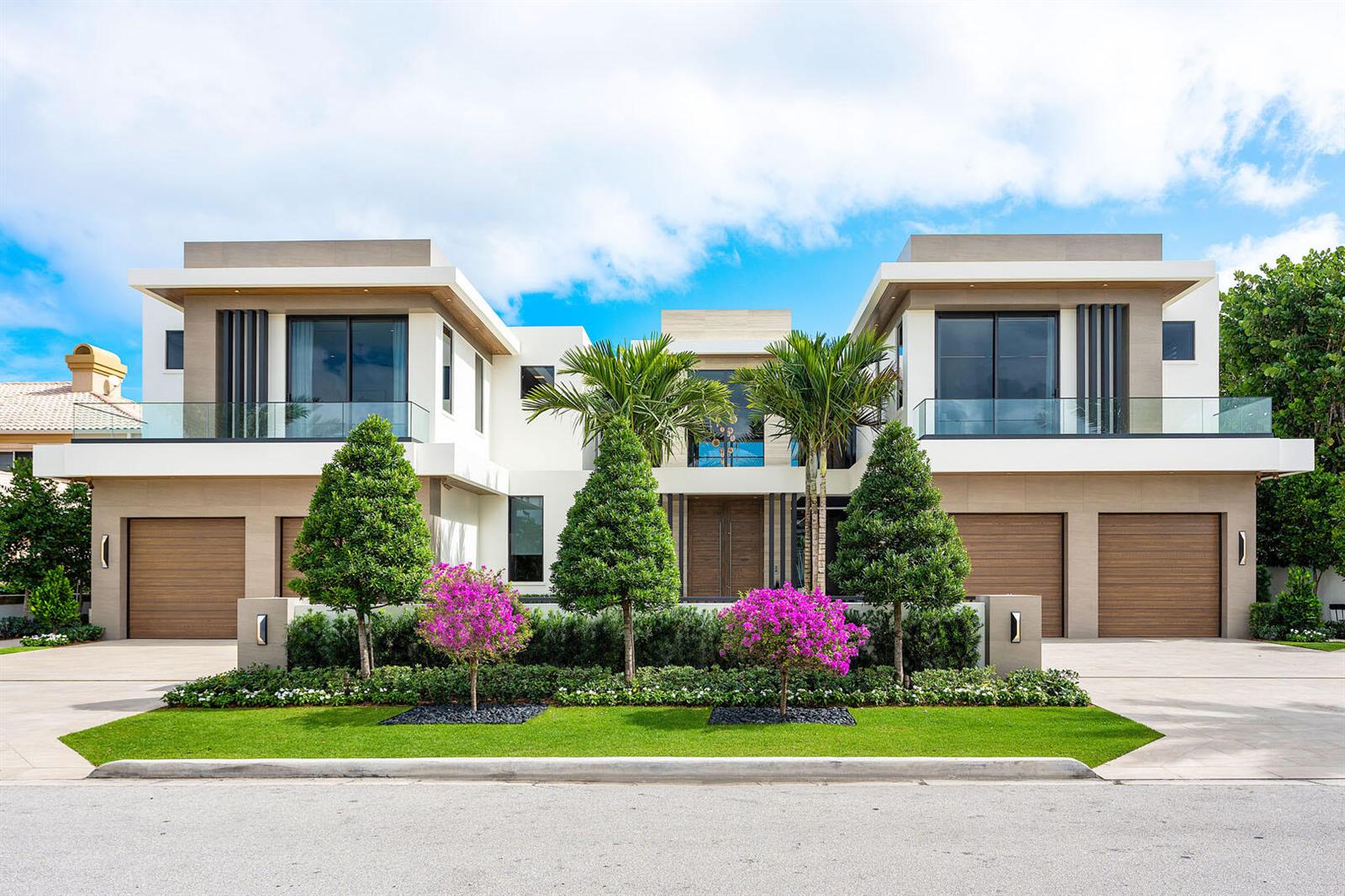 A modern two-story house with a symmetrical facade, three garage doors, and manicured landscaping — 1520 Royal Palm Way, Boca Raton FL 33432, BOCA RATON, FL