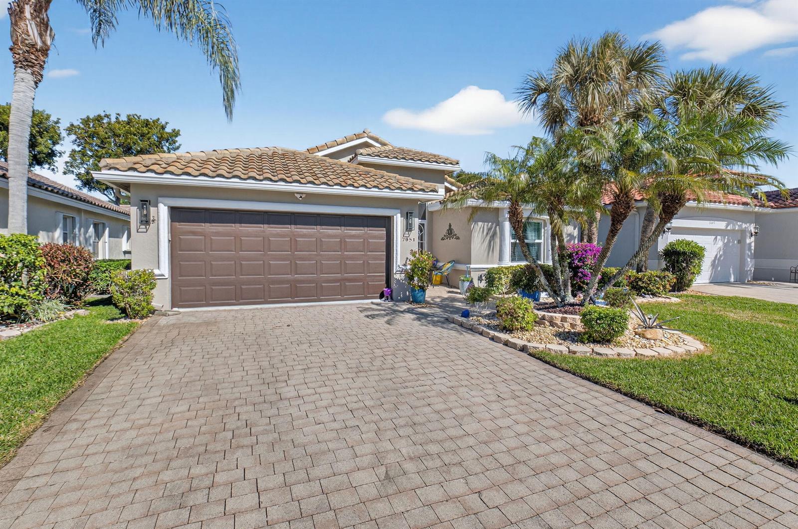 A single-story house with a brown garage door, tiled roof, and a paved driveway — 7051 Trentino Way, Boynton Beach FL 33472, BOYNTON BEACH, FL