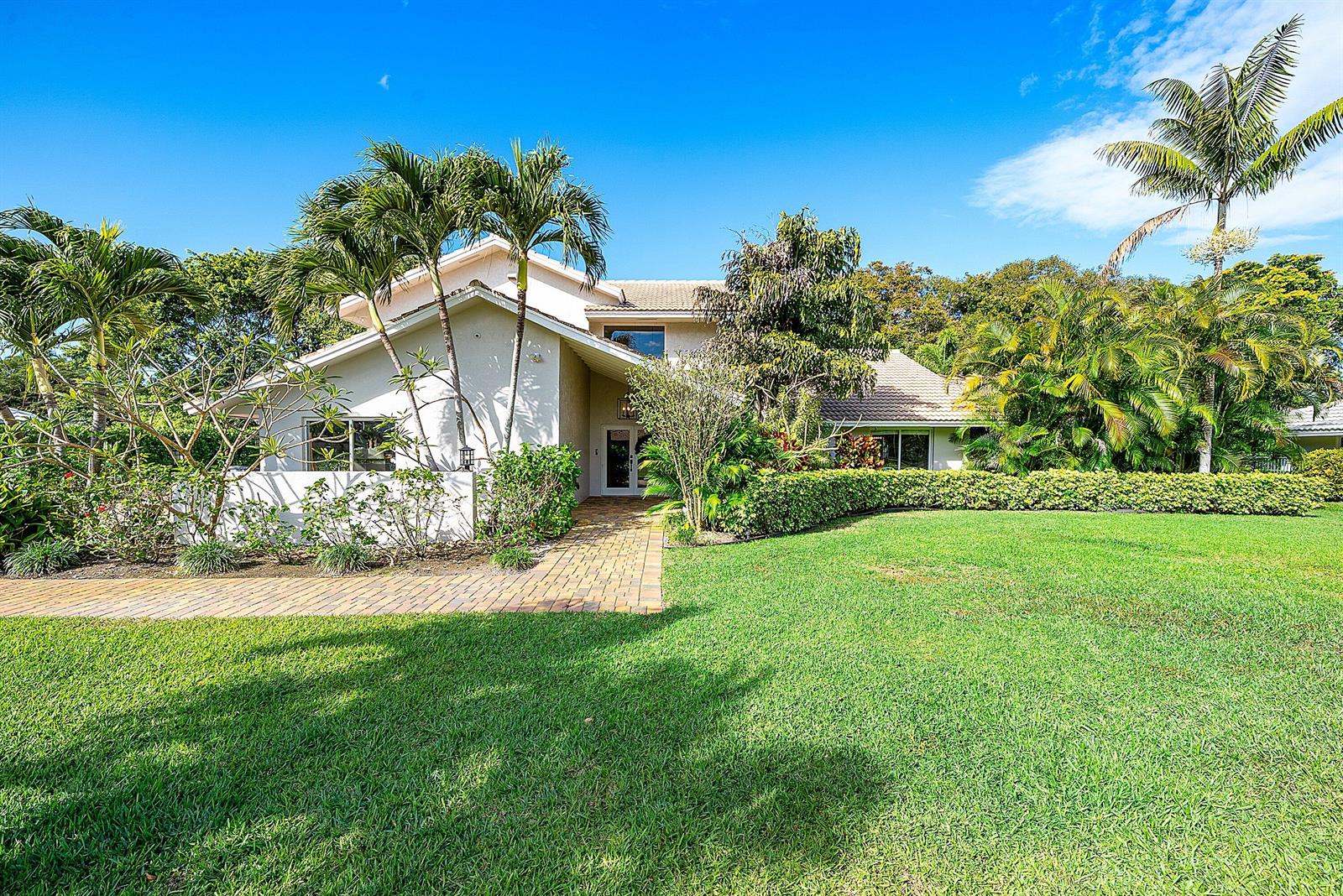 A light-colored house with a brick walkway, palm trees, and a manicured lawn — 10893 Gleneagles Road, Boynton Beach FL 33436, BOYNTON BEACH, FL