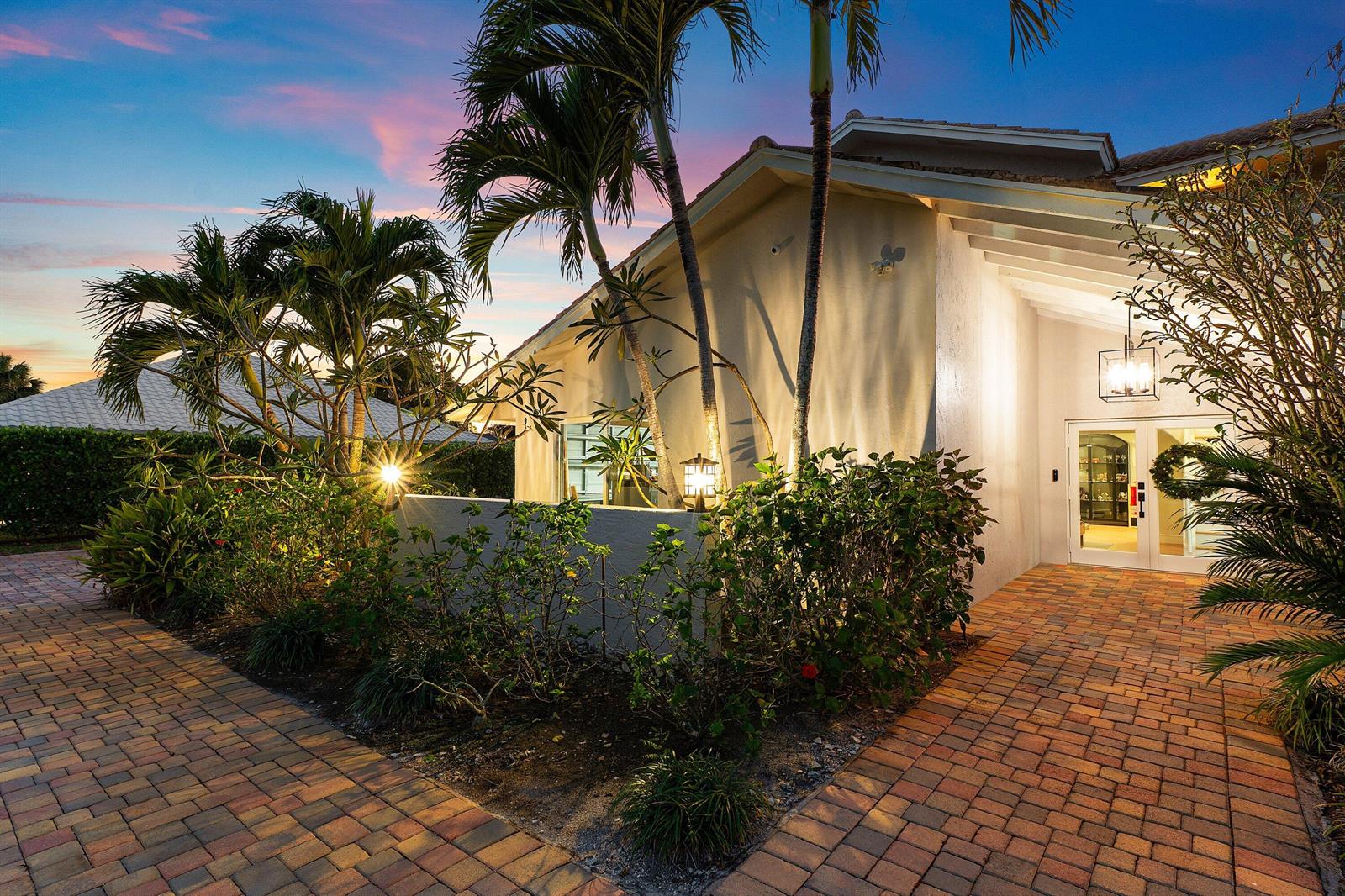 A paved walkway leads to the entrance of a house with palm trees and landscaping — 10893 Gleneagles Road, Boynton Beach FL 33436, BOYNTON BEACH, FL