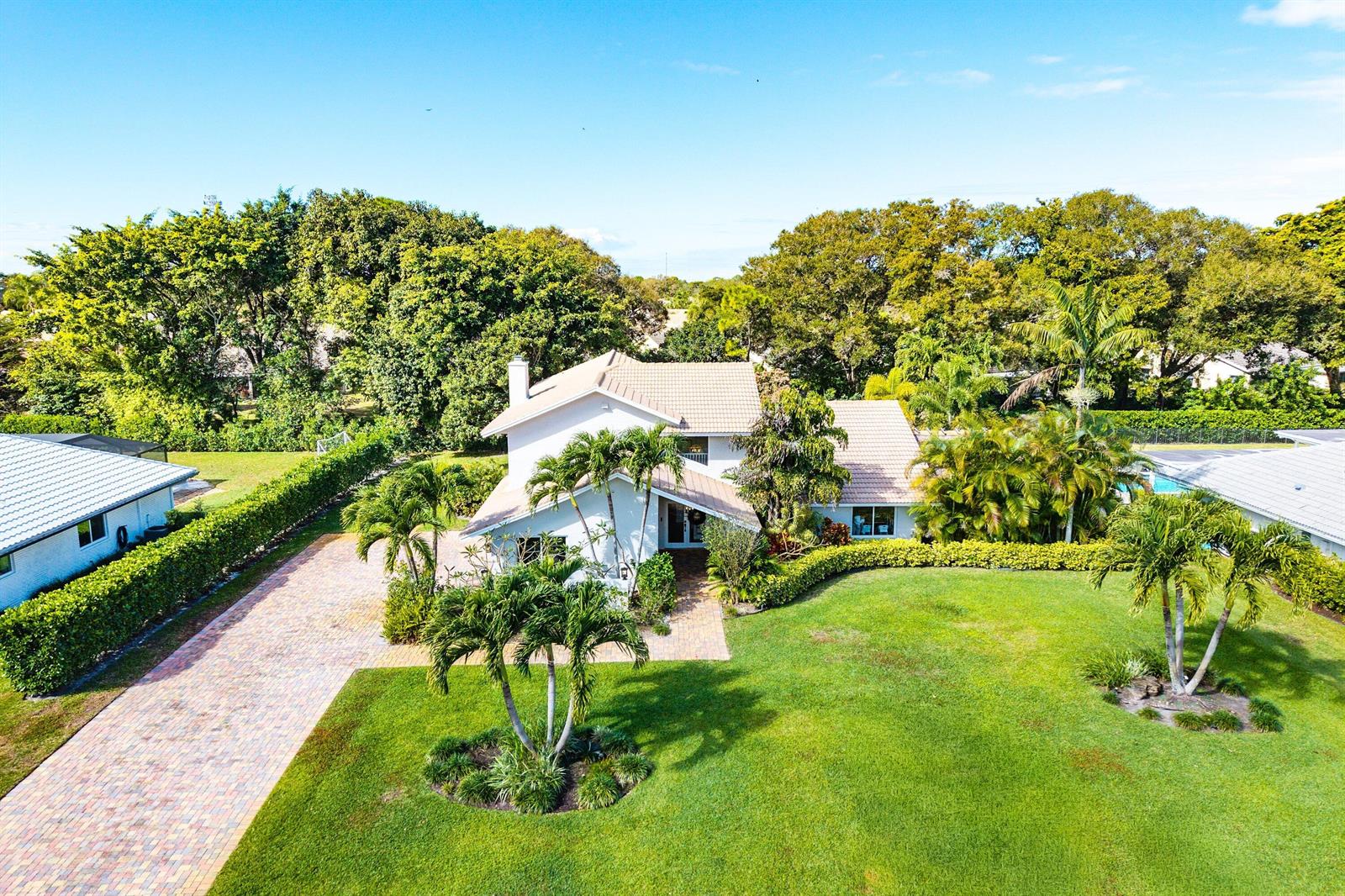 An aerial view of a two-story house with a paved driveway and landscaped lawn — 10893 Gleneagles Road, Boynton Beach FL 33436, BOYNTON BEACH, FL